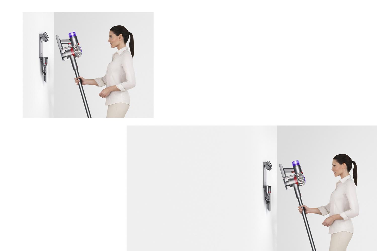 Woman placing Dyson V8 vacuum in the wall dock to charge